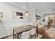 Bright dining room features stylish decor, a modern light fixture, and built-in shelving at 100 Brickworks Ne Cir # 104, Atlanta, GA 30307