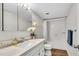 Well-lit bathroom features marble countertop, subway tile, a large mirror and updated fixtures at 2870 Pharr Court South Nw # 2002, Atlanta, GA 30305