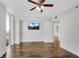 Bedroom features wood-look tile flooring, ceiling fan, and a mounted TV at 2870 Pharr Court South Nw # 2002, Atlanta, GA 30305