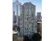 Exterior view of tall modern building with reflective glass windows and surrounding trees at 2870 Pharr Court South Nw # 2002, Atlanta, GA 30305