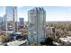 An exterior view shows a tall modern building with reflective glass windows and surrounding trees at 2870 Pharr Court South Nw # 2002, Atlanta, GA 30305