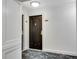 Hallway featuring a dark door with gold accents and patterned carpeting at 2870 Pharr Court South Nw # 2002, Atlanta, GA 30305