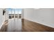 Bright living room boasting wood-look tile flooring, a mounted TV, and floor-to-ceiling windows with city views at 2870 Pharr Court South Nw # 2002, Atlanta, GA 30305