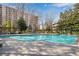 A great in-ground pool is surrounded by lounge chairs and BBQ grills at 2870 Pharr Court South Nw # 2002, Atlanta, GA 30305