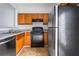 Kitchen featuring black appliances and wooden cabinets at 3610 Ginnis Rd # 4, Atlanta, GA 30331