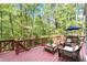 Spacious back deck with wicker seating, perfect for enjoying the surrounding green forest at 4867 Township Trce, Marietta, GA 30066