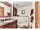 Half bathroom with wood-paneled walls and a decorative carved-wood vanity at 4867 Township Trce, Marietta, GA 30066