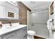 Modern bathroom with wood accent wall, glass shower, and vanity at 4867 Township Trce, Marietta, GA 30066