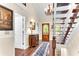 Elegant foyer with hardwood floors, console table, and view of a staircase at 4867 Township Trce, Marietta, GA 30066