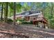 Exterior featuring stone accents, a deck and mature landscaping at 4867 Township Trce, Marietta, GA 30066