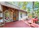 Charming front porch with stone accents, rocking chairs, and a red stained deck at 4867 Township Trce, Marietta, GA 30066