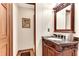 Elegant half bathroom featuring a carved wood vanity and granite countertop at 4867 Township Trce, Marietta, GA 30066