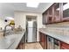 Close-up of the wet bar area with stainless steel fridge and tile backsplash at 4867 Township Trce, Marietta, GA 30066