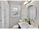 Cozy bathroom featuring tiled shower, modern fixtures, and stylish vanity with oval mirror at 488 Park Valley Nw Dr, Atlanta, GA 30318