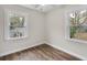 Neutral bedroom with two windows providing natural light and views, with hardwood flooring at 488 Park Valley Nw Dr, Atlanta, GA 30318