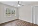 Neutral room with hardwood flooring, a large window, and a ceiling fan at 488 Park Valley Nw Dr, Atlanta, GA 30318