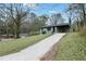 Quaint single-level home on a grassy lot with a private driveway and attached carport at 488 Park Valley Nw Dr, Atlanta, GA 30318