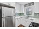 Charming kitchen featuring stainless steel appliances, white cabinets, and modern countertops and backsplash at 488 Park Valley Nw Dr, Atlanta, GA 30318