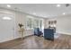 Light-filled living room featuring wood floors, stylish chairs, and large windows at 488 Park Valley Nw Dr, Atlanta, GA 30318