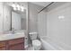 This bathroom features a tub and shower combination with a white tiled surround, and a cherry wood vanity sink at 730 Reeves Lake Sw Dr, Marietta, GA 30064