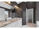 Bathroom with dual sinks, granite countertops, and a tub beneath the window at 730 Reeves Lake Sw Dr, Marietta, GA 30064