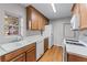 This kitchen features light wood cabinetry, modern white appliances, and abundant natural light with hardwood flooring at 730 Reeves Lake Sw Dr, Marietta, GA 30064