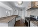 Well-lit kitchen featuring stainless steel appliances, granite countertops, and a view into the living room at 730 Reeves Lake Sw Dr, Marietta, GA 30064