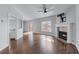 Bright living room with hardwood floors, fireplace, ceiling fan and access to the outdoor deck at 730 Reeves Lake Sw Dr, Marietta, GA 30064