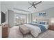 Serene bedroom with a tray ceiling, plush carpet, a king bed, and a cozy sitting area by the window at 730 Reeves Lake Sw Dr, Marietta, GA 30064