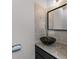 Stylish powder room featuring a black vessel sink, granite countertop, and modern fixtures at 730 Reeves Lake Sw Dr, Marietta, GA 30064