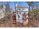 Home's rear exterior showcasing a multi-level deck, foundation and natural landscaping on a wooded lot at 730 Reeves Lake Sw Dr, Marietta, GA 30064