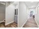 Finished basement hallway featuring wood-look floors and a storage cabinet at 7295 Hickory Bluff Dr, Cumming, GA 30040