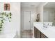 Bright bathroom featuring single sink vanity with dark wood, white countertop, and tiled flooring at 7295 Hickory Bluff Dr, Cumming, GA 30040