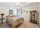 Bedroom with a decorative quilt bed, ceiling fan, and display cabinet at 7295 Hickory Bluff Dr, Cumming, GA 30040