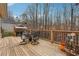 Outdoor deck featuring elegant metal patio furniture, plants, and a wooded view at 7295 Hickory Bluff Dr, Cumming, GA 30040