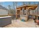 Outdoor wooden deck featuring a covered BBQ area and additional seating perfect for entertaining guests at 7295 Hickory Bluff Dr, Cumming, GA 30040