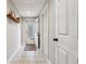 Basement hallway features a charming door to the exterior, tile floors, and neutral paint at 7295 Hickory Bluff Dr, Cumming, GA 30040