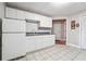 Functional kitchen features white cabinetry and a neutral palette, maximizing space efficiency at 7295 Hickory Bluff Dr, Cumming, GA 30040