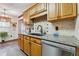 Kitchen area boasts wooden cabinetry, granite countertops, mosaic tile backsplash, and stainless steel appliances at 7295 Hickory Bluff Dr, Cumming, GA 30040