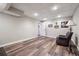 Spacious finished basement living room with dark wood-look flooring and neutral paint at 7295 Hickory Bluff Dr, Cumming, GA 30040