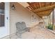 View of the outdoor patio with a bench, landscaping and a view to the wooded backyard at 7295 Hickory Bluff Dr, Cumming, GA 30040