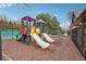 Community playground featuring slides and swings with seating areas at 7295 Hickory Bluff Dr, Cumming, GA 30040