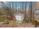 View of a shed with a workbench set against a wooded lot at 7295 Hickory Bluff Dr, Cumming, GA 30040