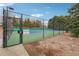 Fenced tennis court with net and community rules posted at 7295 Hickory Bluff Dr, Cumming, GA 30040