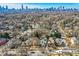 A beautiful aerial view of a tree lined neighborhood with the city skyline in the distance at 959 Glen Arden Ne Way, Atlanta, GA 30306