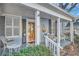 Inviting front porch with seating area, classic columns, and beautiful wood door at 959 Glen Arden Ne Way, Atlanta, GA 30306