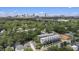 Aerial view of new townhome construction amid lush trees with a city skyline backdrop at 1145 Kirkwood Se Ave # 4, Atlanta, GA 30316