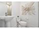 Stylish half bath features sleek pedestal sink and a modern decorative art piece at 1145 Kirkwood Se Ave # 4, Atlanta, GA 30316