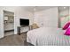 Bedroom with a large flat screen, modern console table and ensuite bathroom at 1145 Kirkwood Se Ave # 4, Atlanta, GA 30316