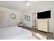 Bright bedroom with a ceiling fan, sleek dresser, and ensuite bathroom at 1145 Kirkwood Se Ave # 4, Atlanta, GA 30316